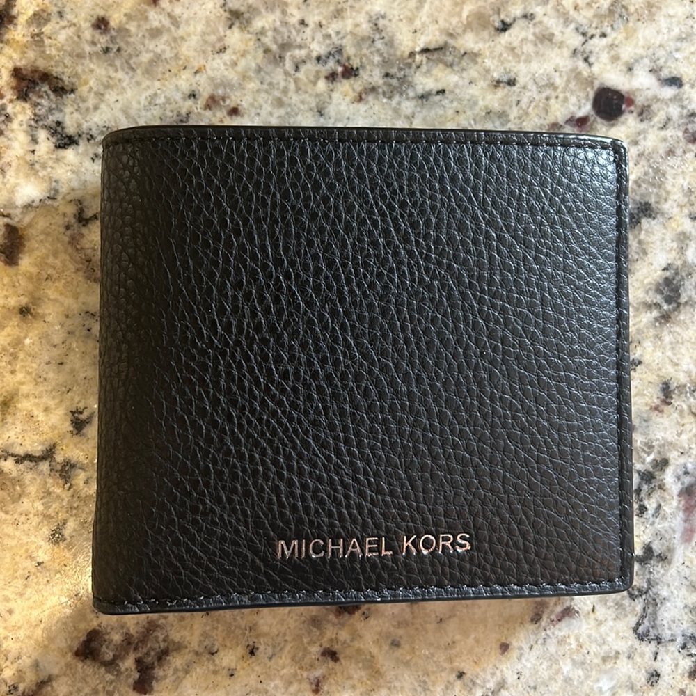 Brand new Michael Kors men’s wallet with tag.